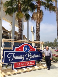 Tommy stands proudly next to his sign.